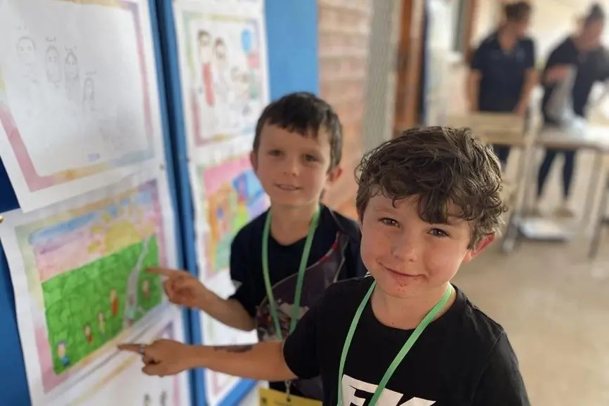 Cruz and Carter White find their family portrait. PHOTO: Supplied