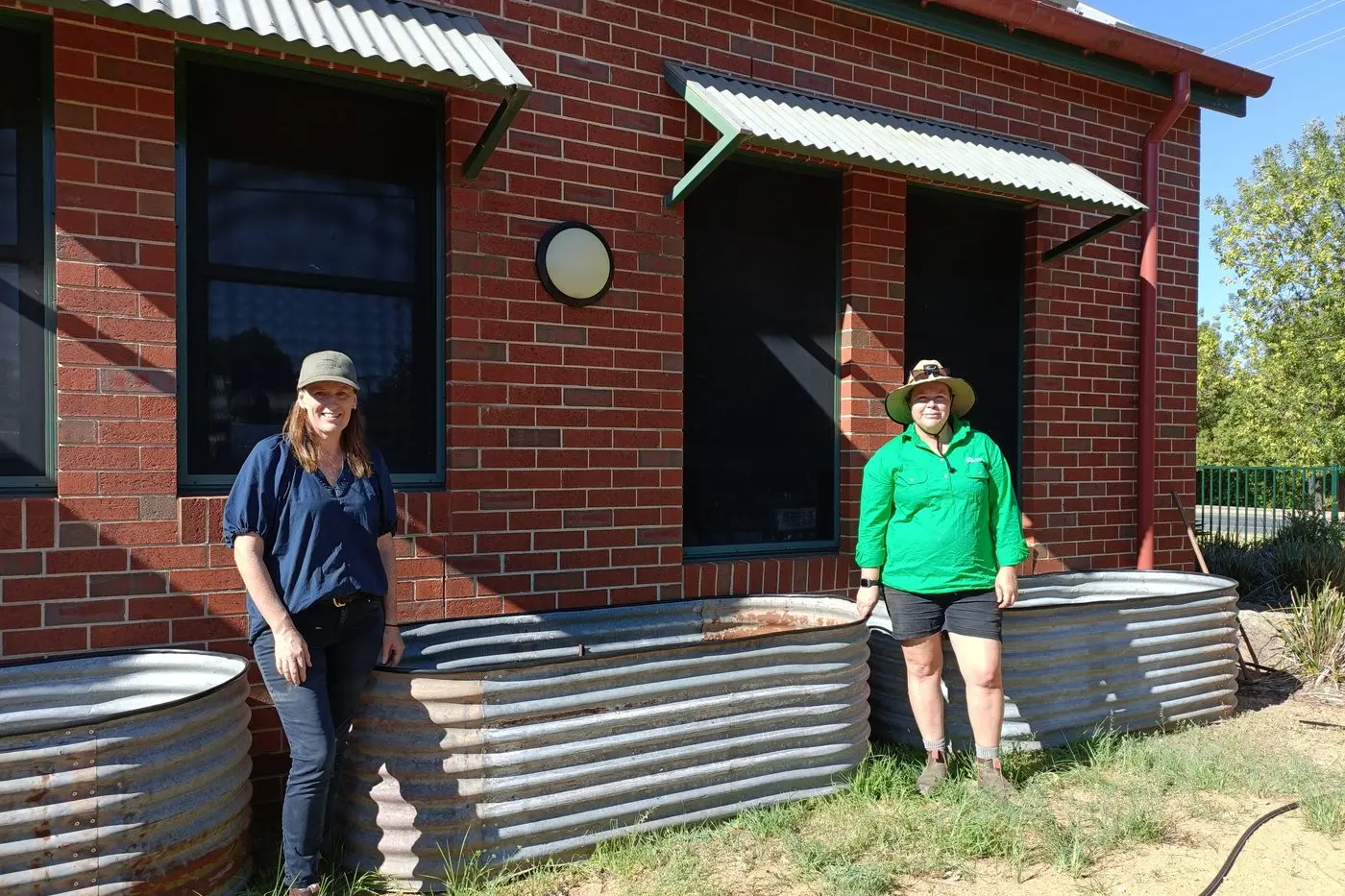 Natalie Caruana. and Melanie Cooper installing a compost bin.