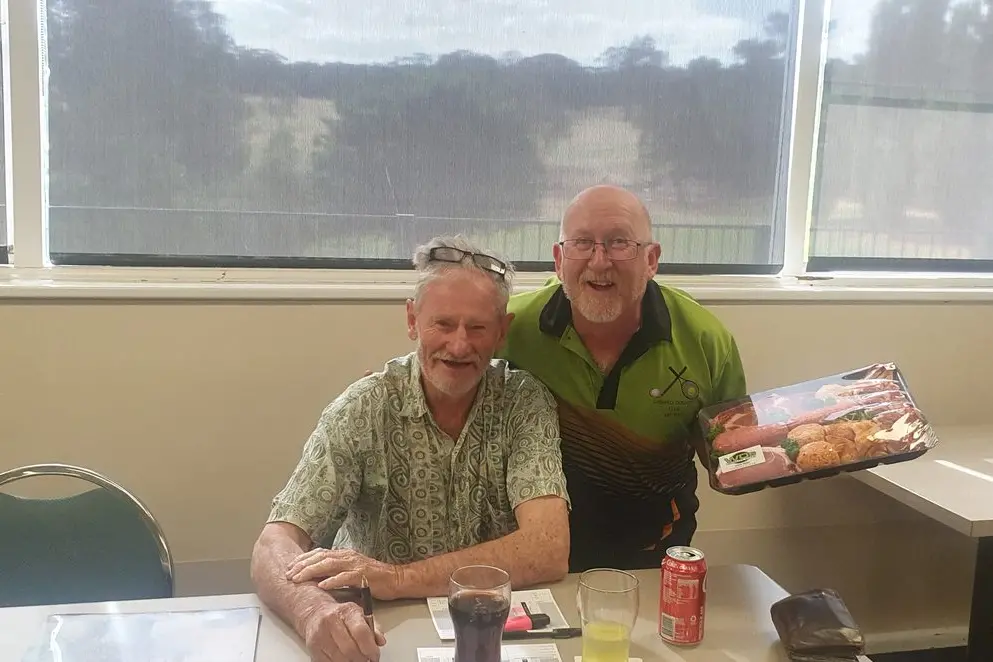 Brian Hughes congratulates Michael Neill on winning the men\\'s division at the Brian Hughes Golf Day. PHOTO: Supplied