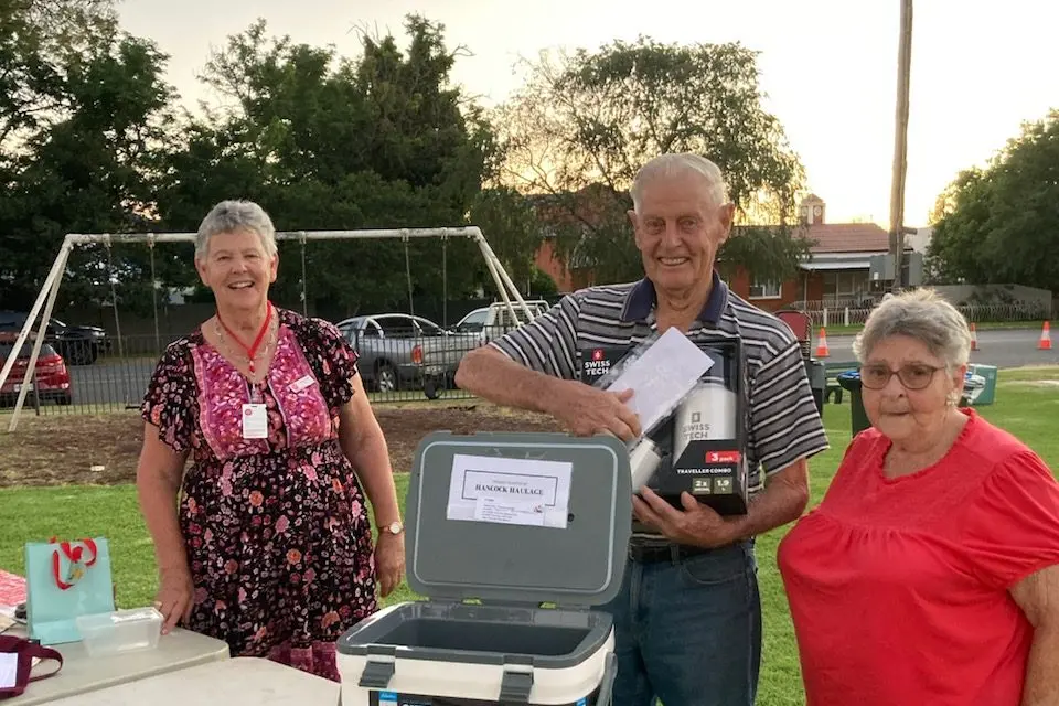 Dorothy Starr, and Glenice Clarke congratulate Barry Knight on drawing the winning raffle ticket. PHOTO: Supplied