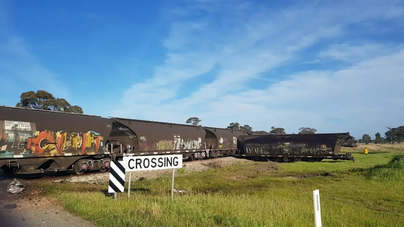 Stock truck and freight train collide at level crossing