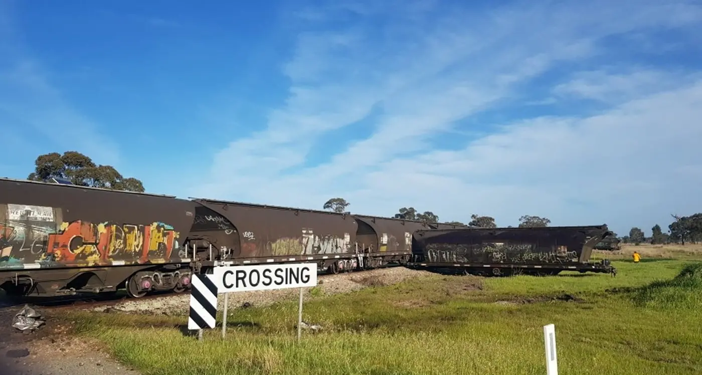 Stock truck and freight train collide at level crossing