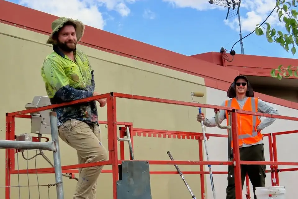 Mural artists Daniel Walton and Scott Nagy begins work on the Grenfell Motel Mural, PHOTO: Courtesy of Jenn Graham.