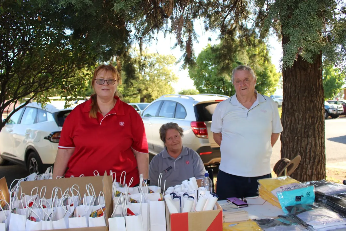 Jodie McInnes,Barbara Nash and Roy Nash were operating the Salvation Army\\'s stand at the Carols.