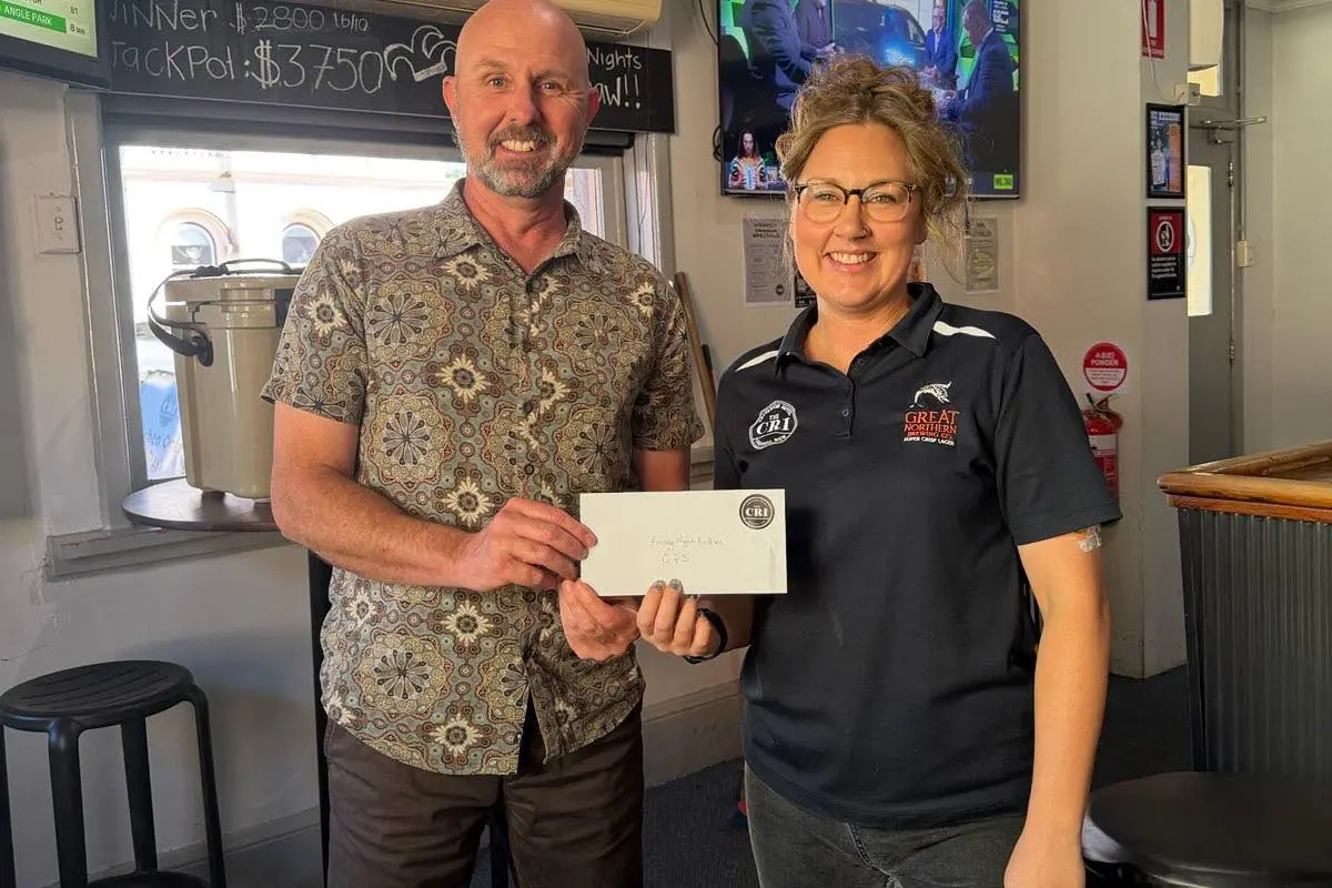 <p>Kat Brenner presenting Grenfell Public School principal Brent Cartwright with $500. PHOTO: Grenfell Public School</p>\\n