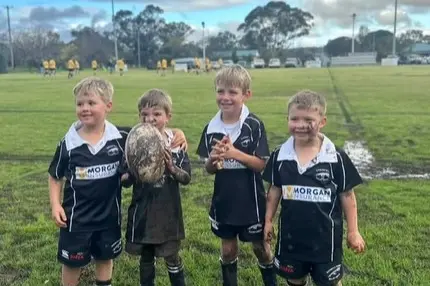 <p>Juniors had fun playing rugby in the mud.</p>\\n