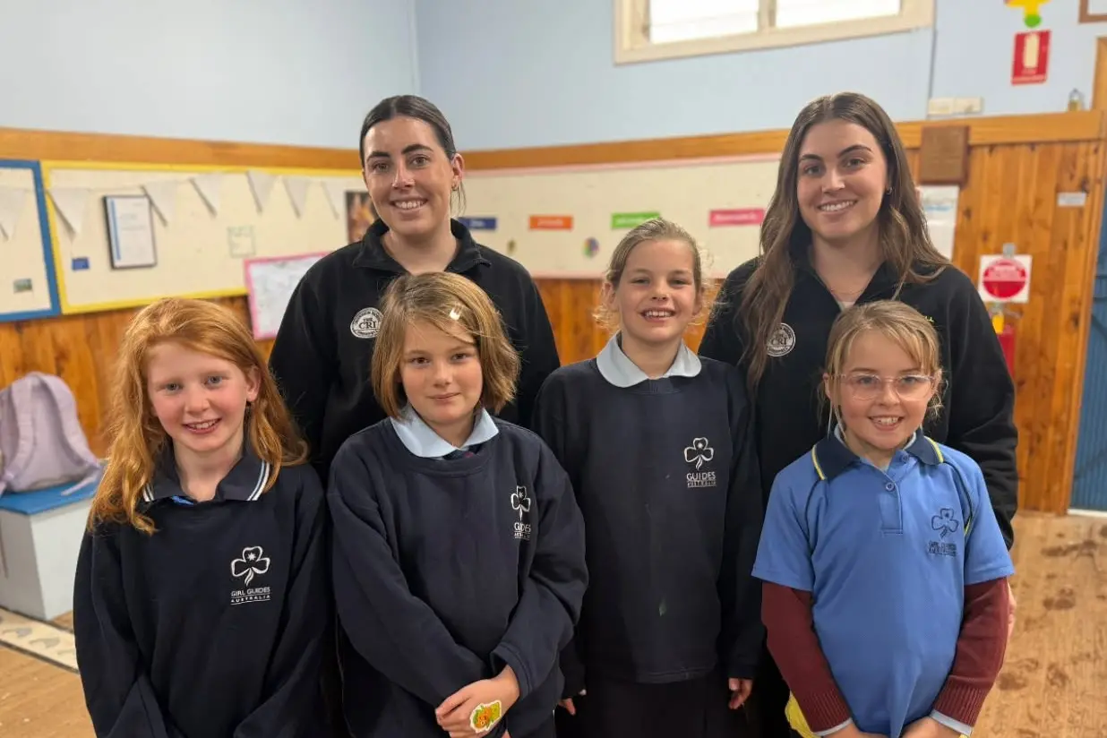 <p>Grenfell Goannas league tag players Olivia and Sophie presenting the Grenfell Girl Guides with $300. PHOTO: Grenfell Goannas </p>\\n