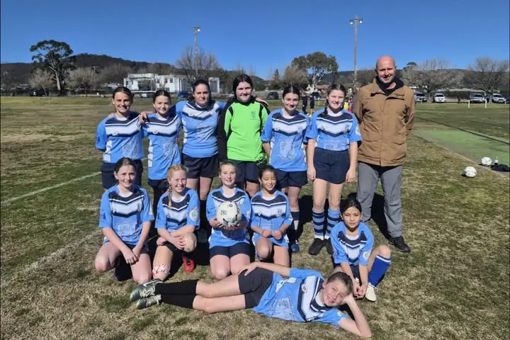<p>Grenfell Public School girls soccer team: Back row L/R - Hilary, Mae, Abbey, Faith, Lily, Georgie, Mr Cartwright. First row L/R - Ebony, Payten, Adelaide, Ella, Marlie and Bronte (laying down). </p>\\n