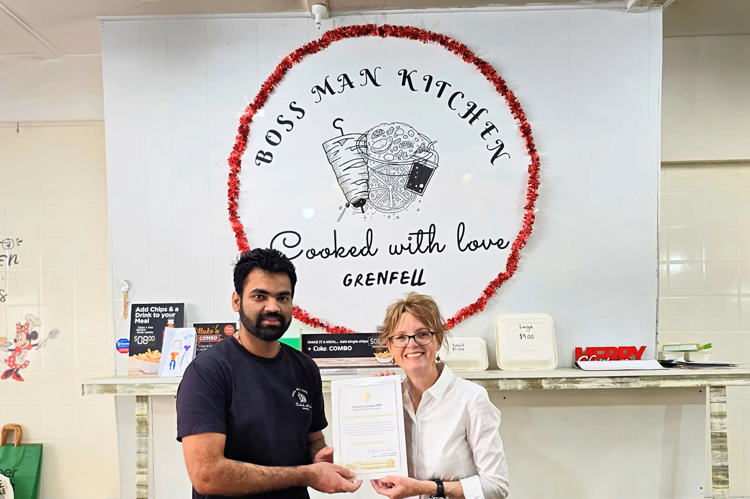 <p>Mohit from Boss Man Kitchen in Grenfell receiving his certificate from Member for Cootamundra Steph Cooke.</p>\\n