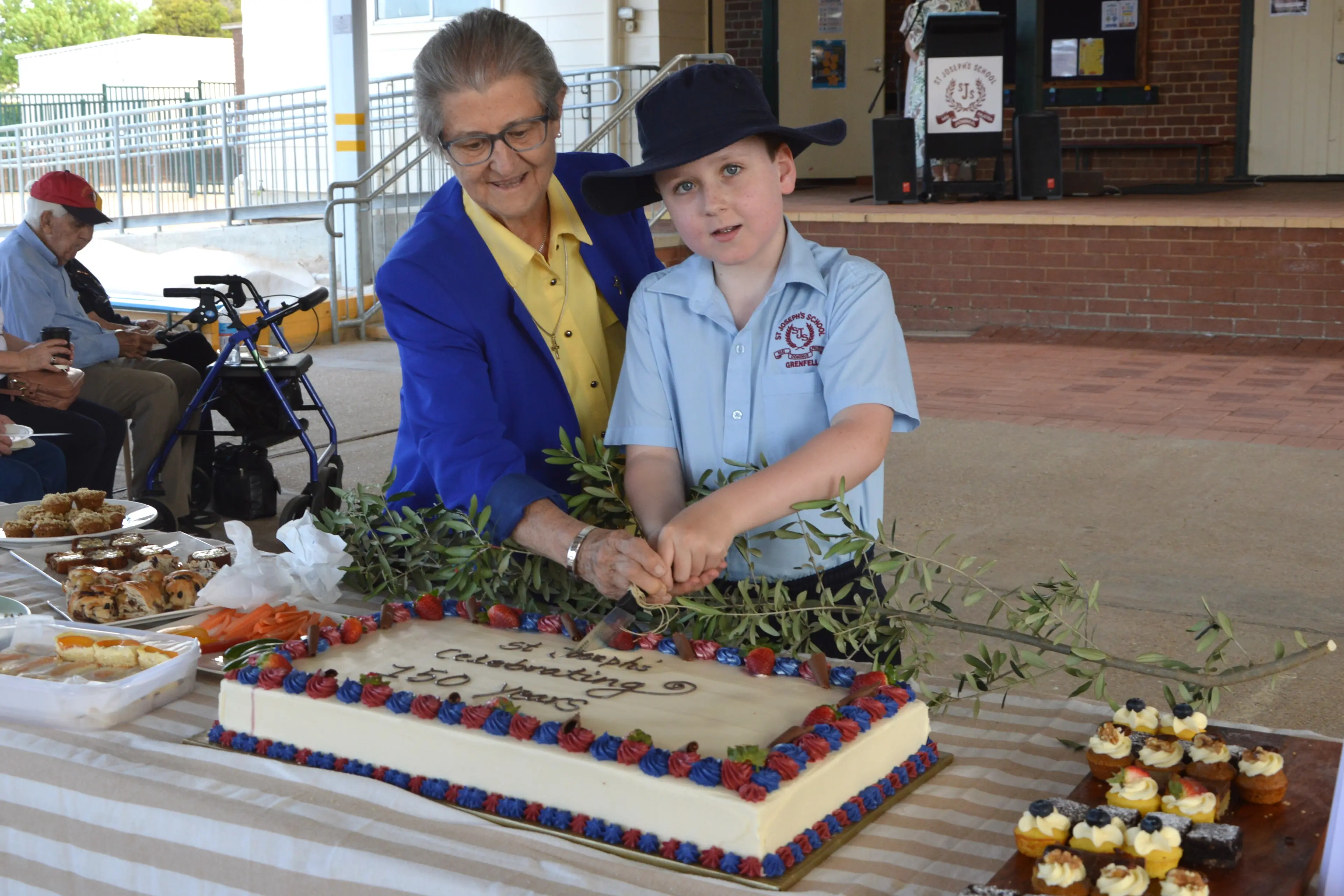 <p>Sister Mary Corkeron and third generation St Joseph\\'s Public School student Darcy Gray cut the 150 year anniversary cake. PHOTOS: Madeline Blackstock</p>\\n